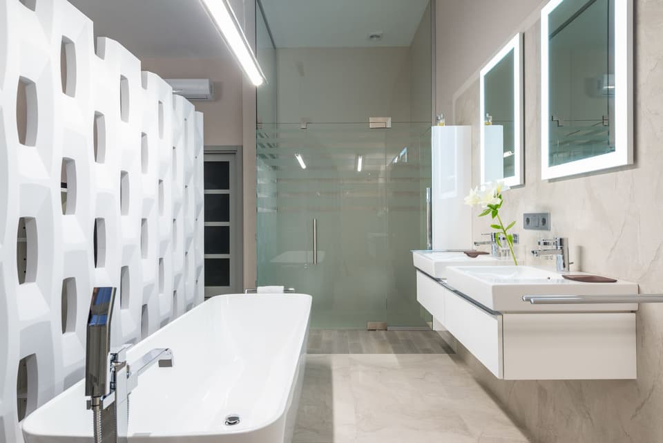 The finished bathroom: a freestanding bath and full-height glass